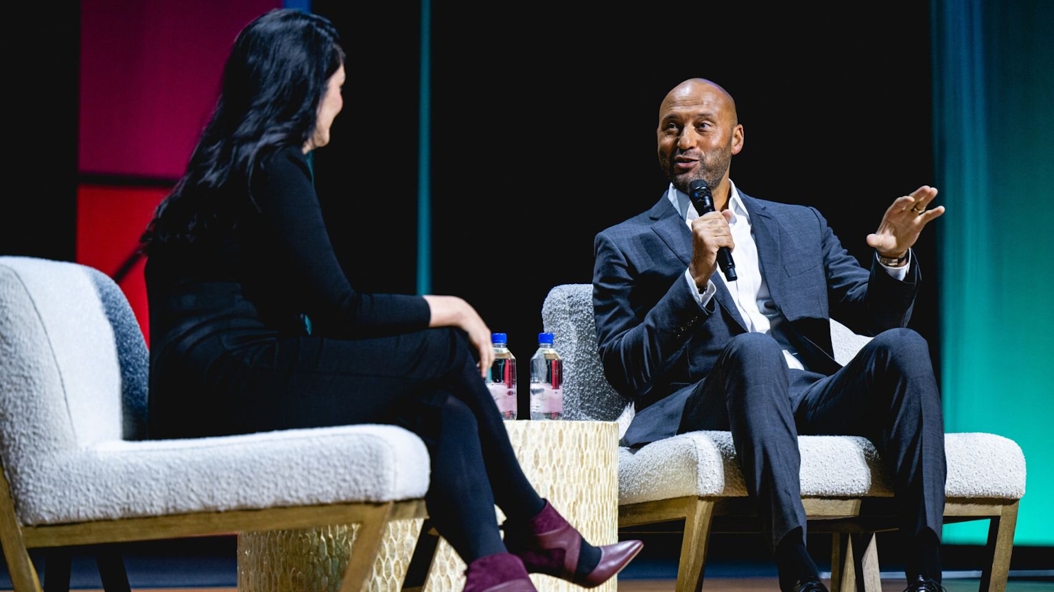 Two people in conversation on stage.