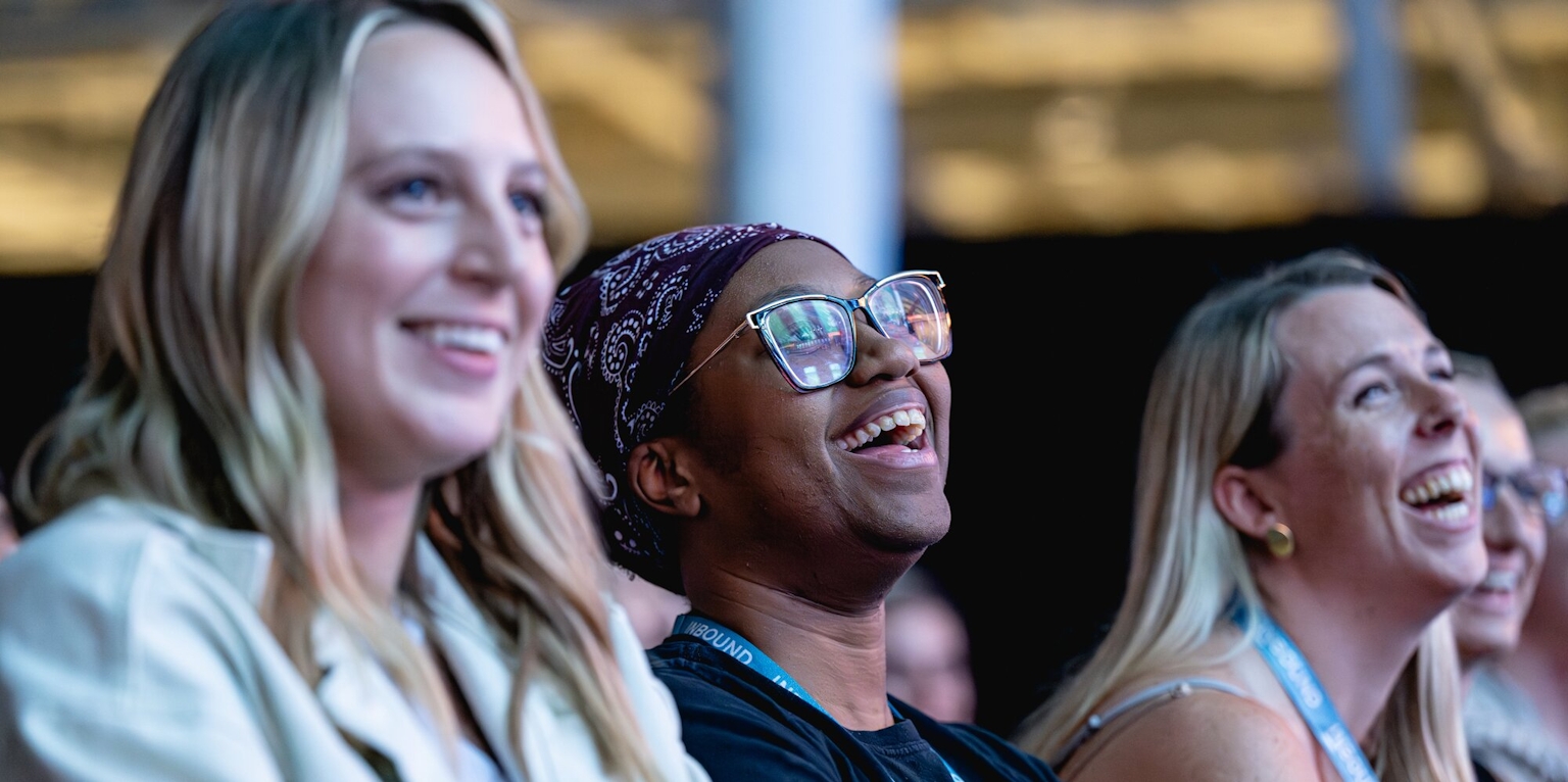 Two female audience members smiling